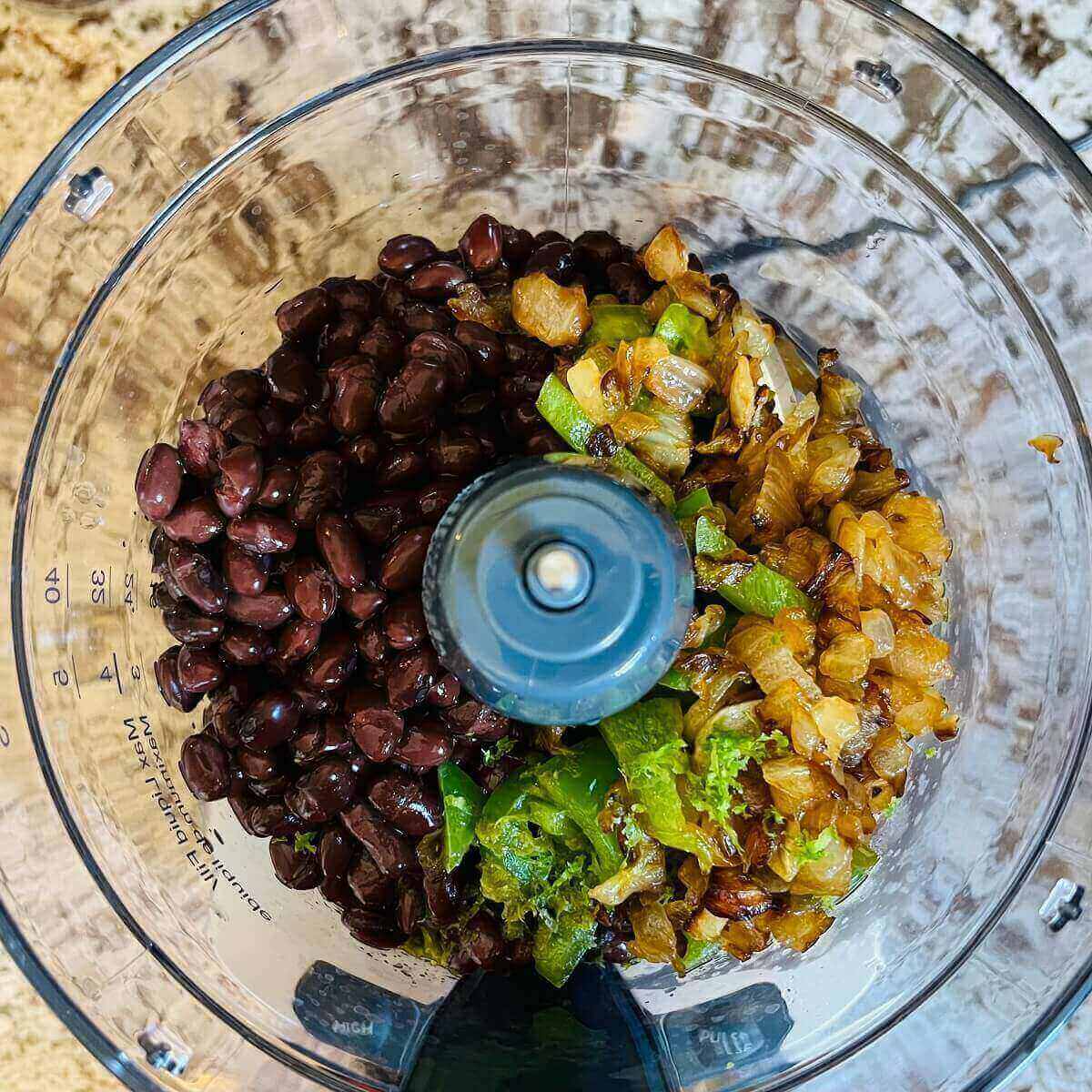 Ingredients for bean dip in a food processor.