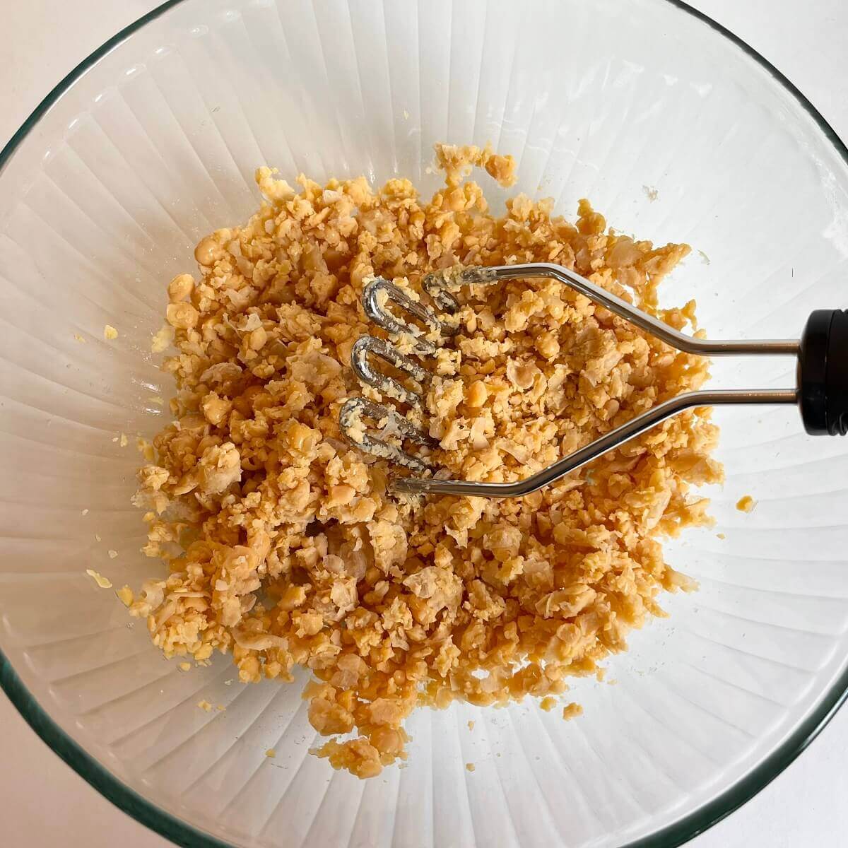 Mashed Chickpeas in a large glass bowl.