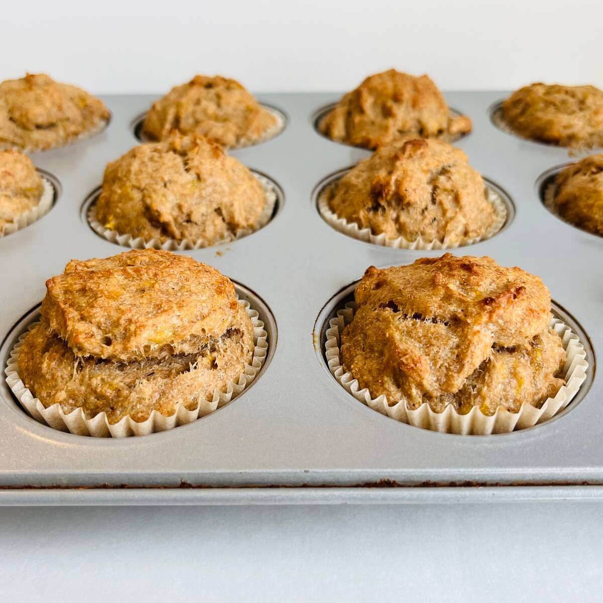 Banana muffins in a metal muffin pan.