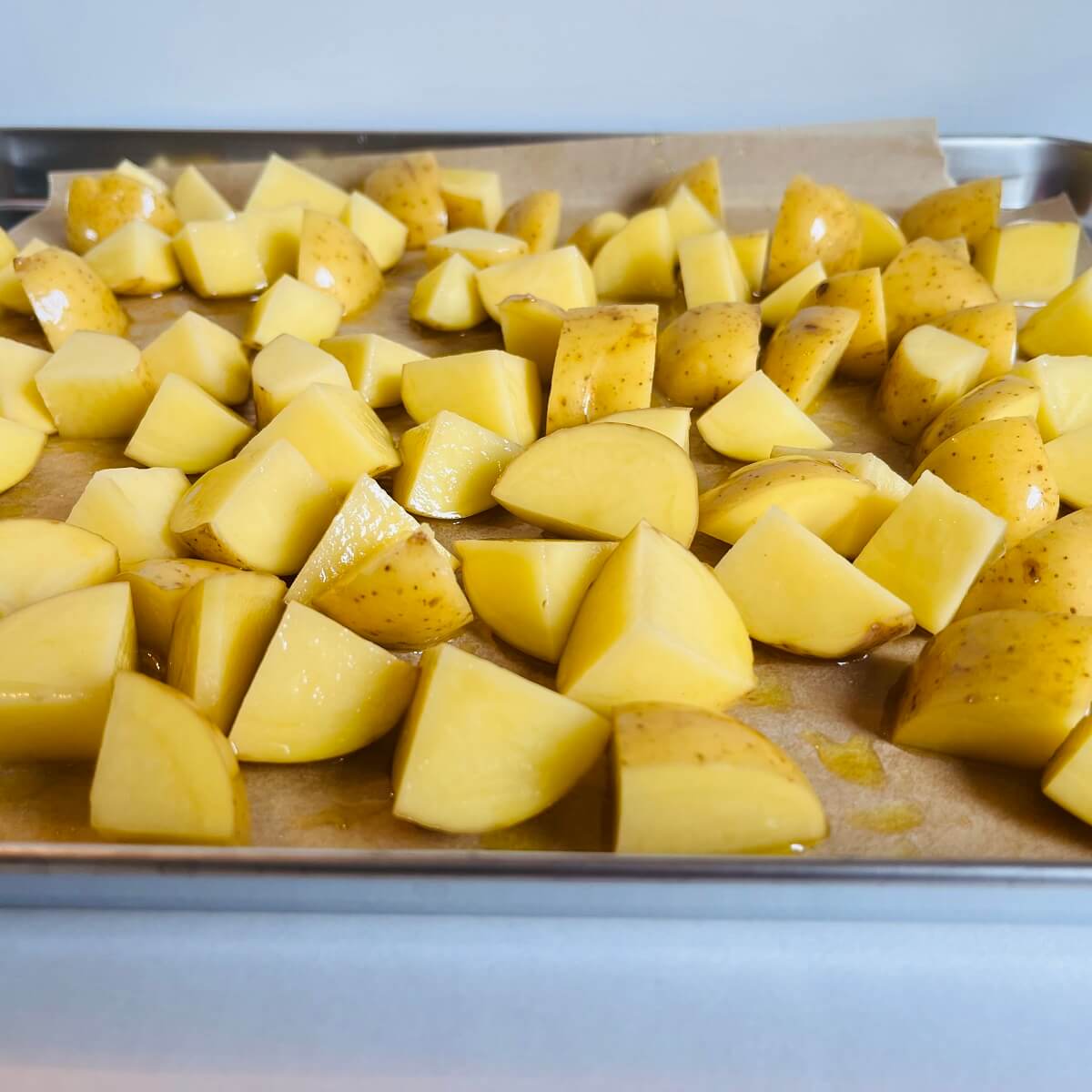 Chopped potatoes on a sheet pan.