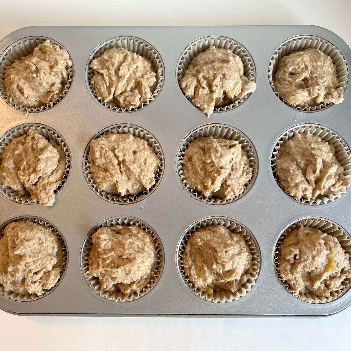 Raw banana muffins in a metal pan.