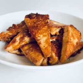 A pile of cooked tofu in a bowl.