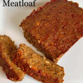 Meatloaf with two slices cut on a white platter.