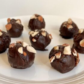 Chocolates arranged on a white plate.