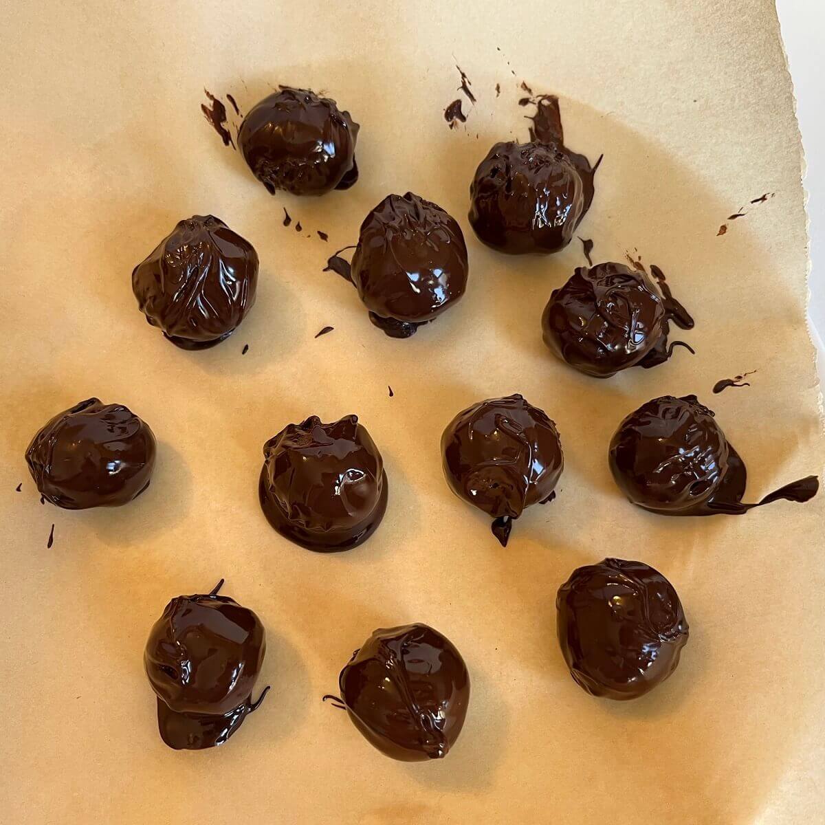 Chocolate truffles on a piece of parchment paper.