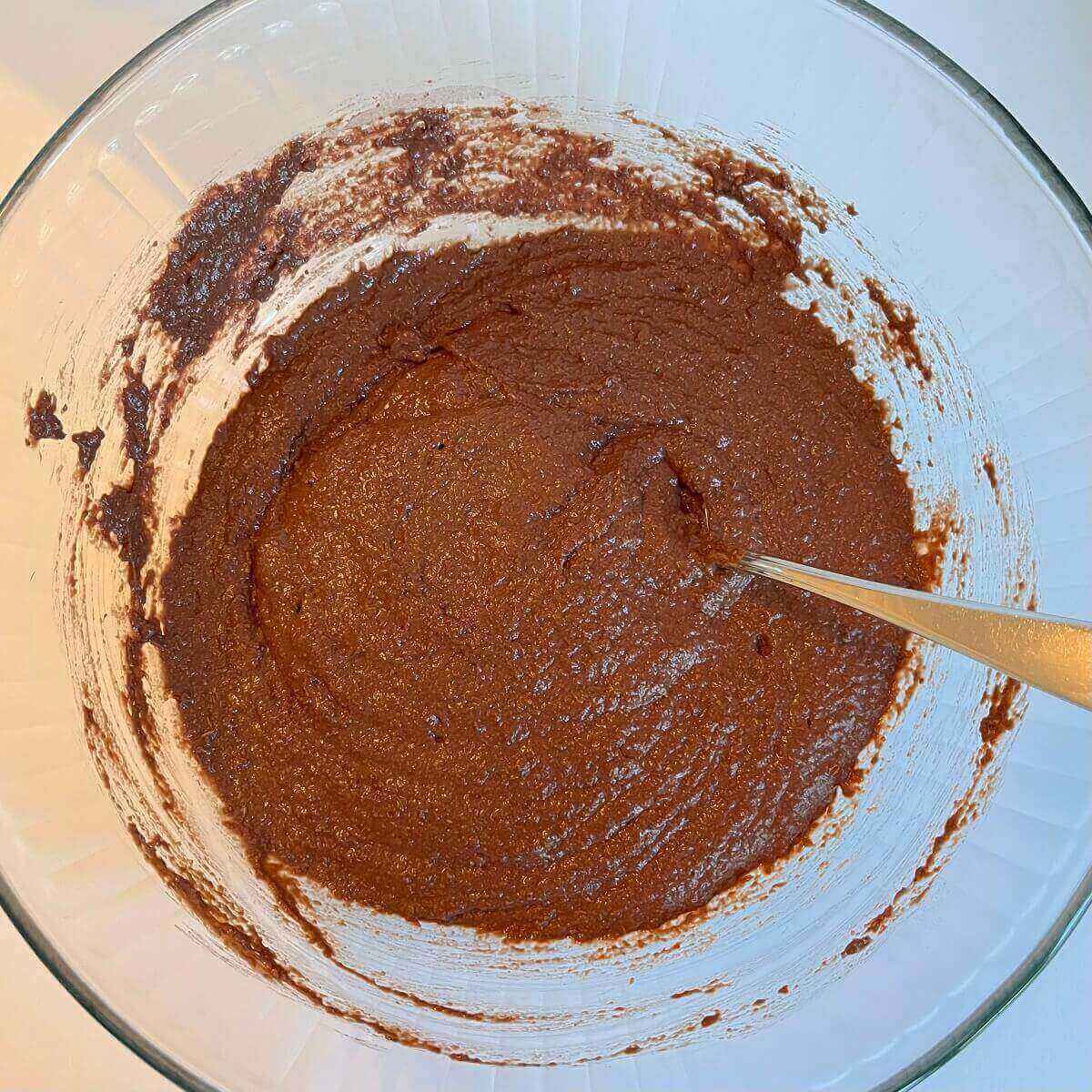 Brown bread dough in a mixing bowl.