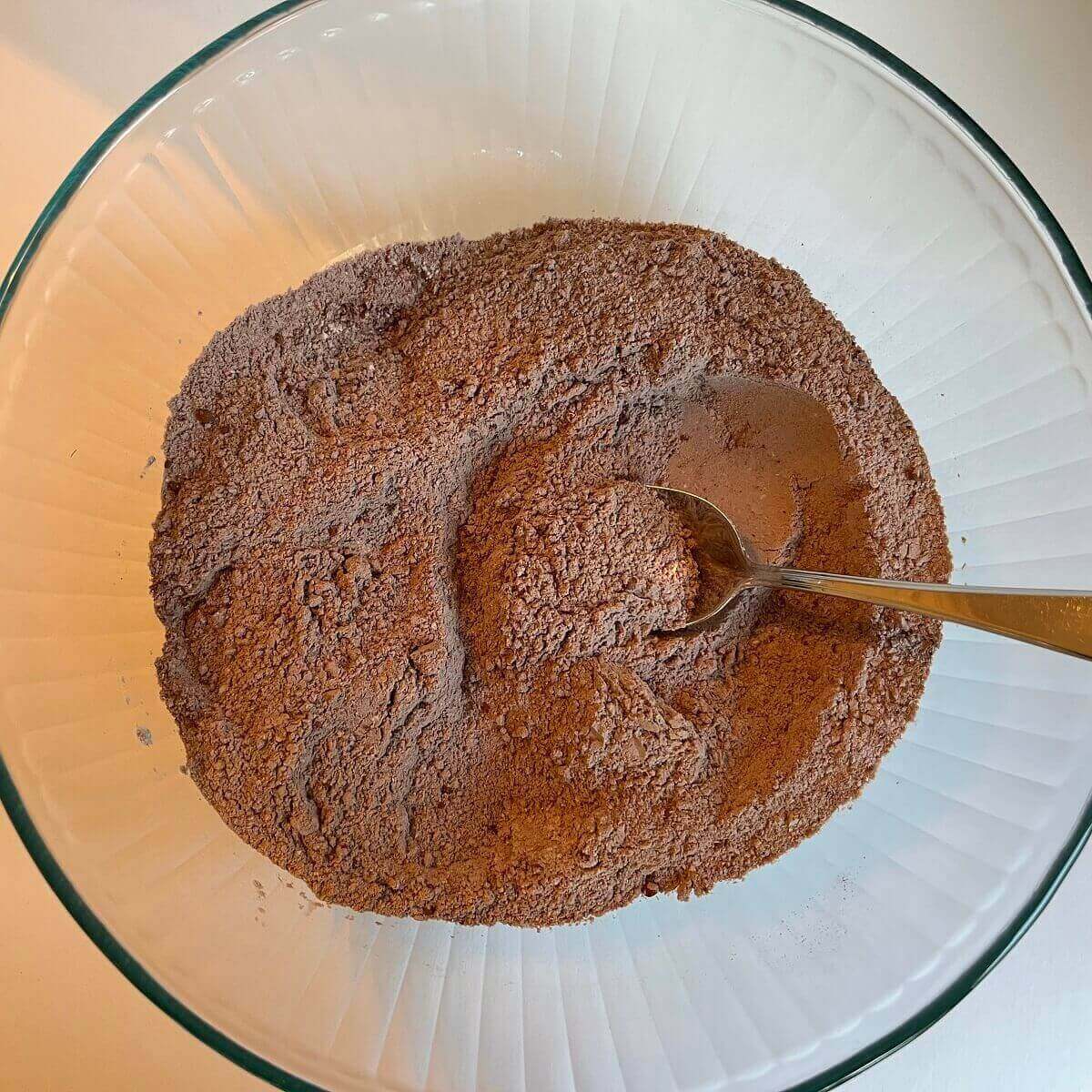 Dry ingredients for bread in a glass mixing bowl.