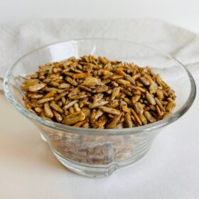 Spiced sunflower seeds in a glass bowl.
