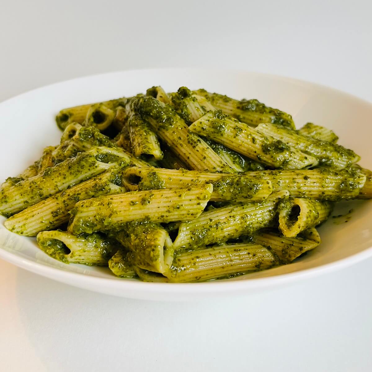 Noodles smothered in a green kale pasta sauce.