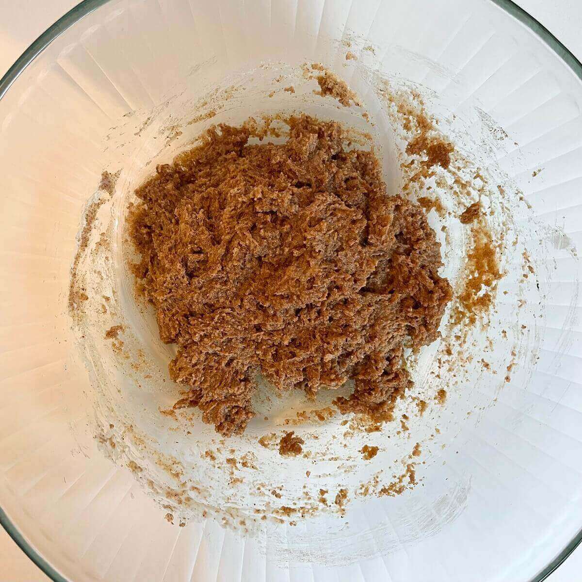 Almond butter dough in a large glass mixing bowl.