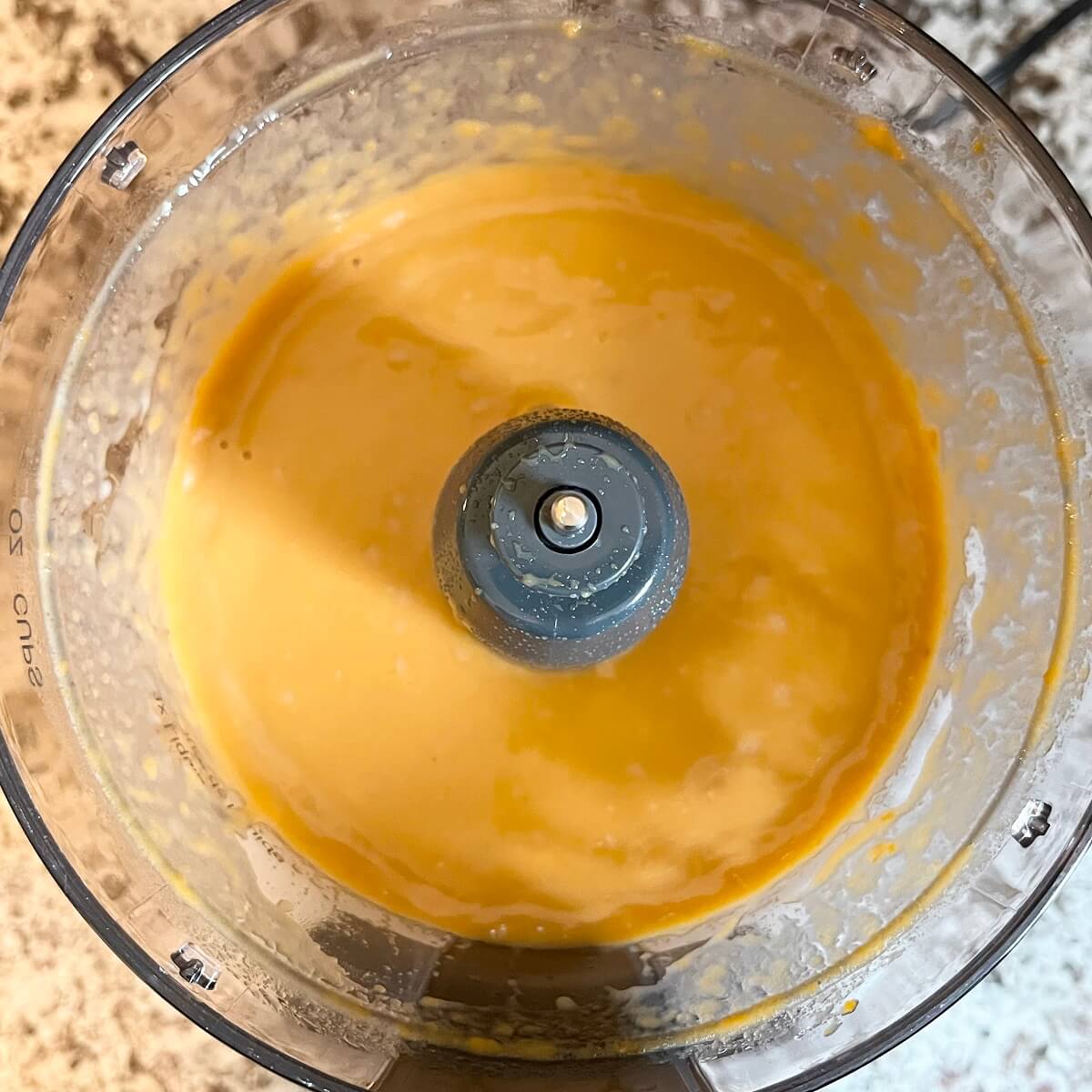 Blended ingredients for muffin batter in a food processor.
