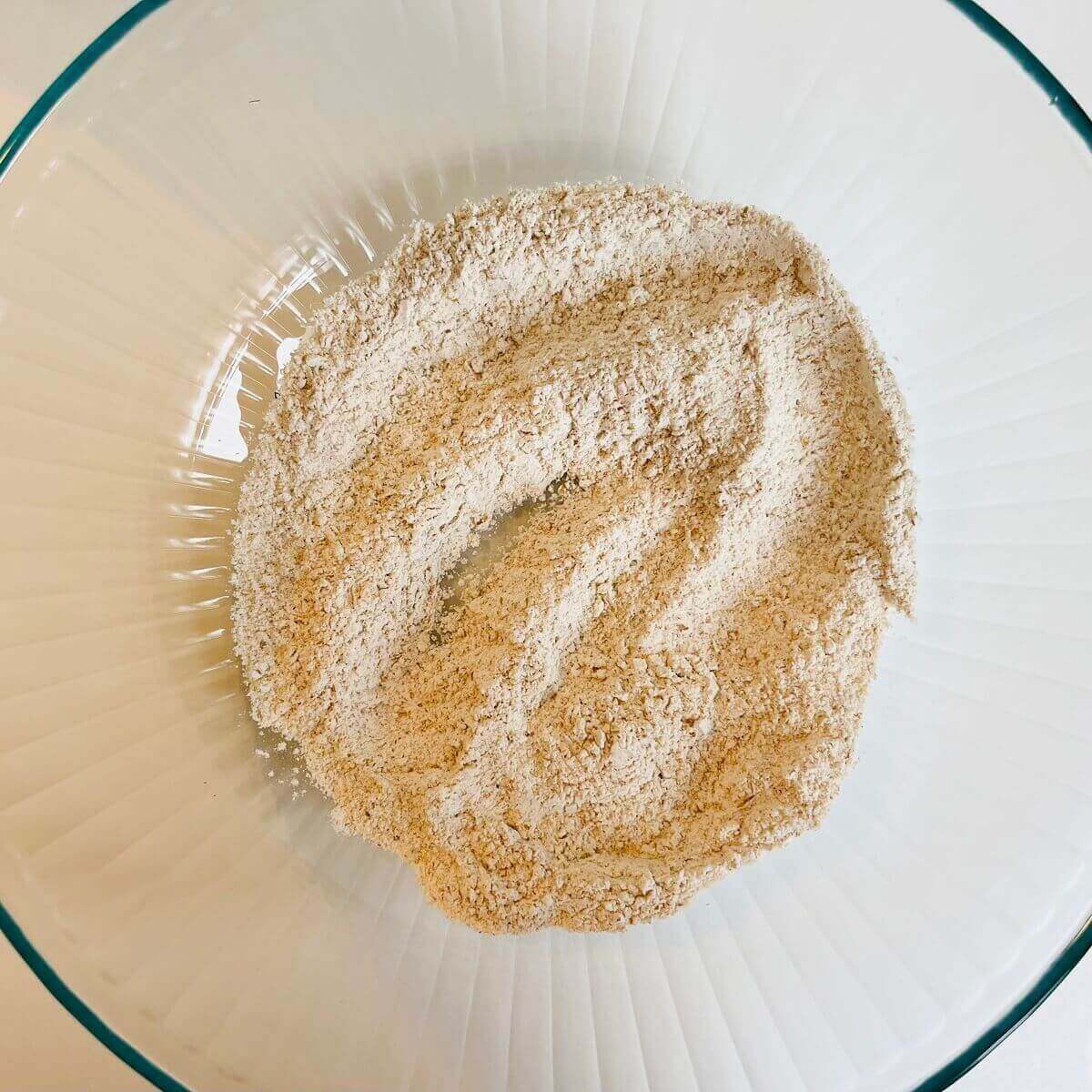 Flour and baking powder in a glass mixing bowl.
