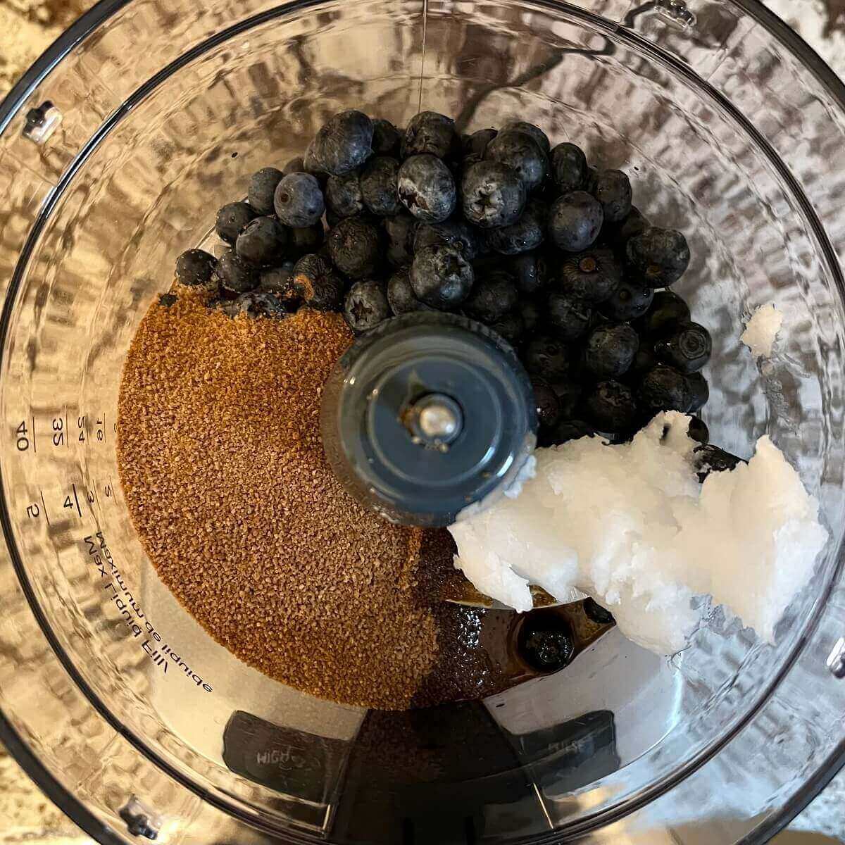 Ingredients for blueberry cookies in a food processor.