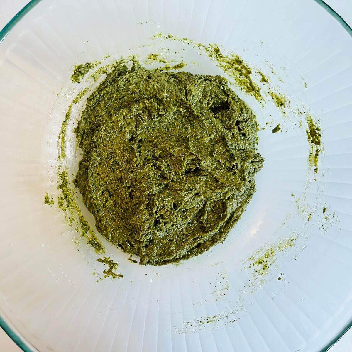 Kale cookie dough in a glass mixing bowl.