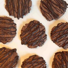 Eight monk fruit cookies on a white plate.