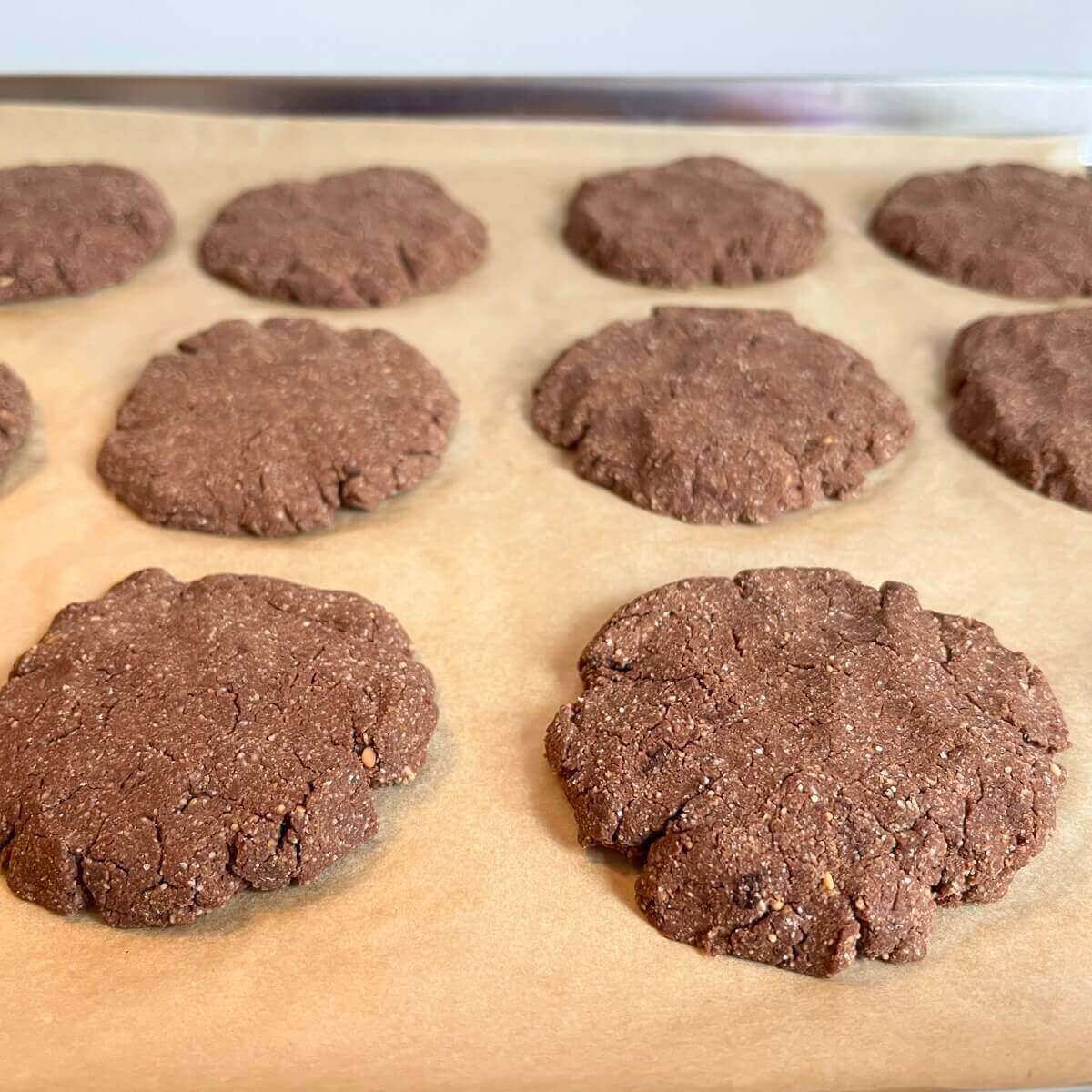 freshly baked cookies on a sheet pan lined with parchment paper.