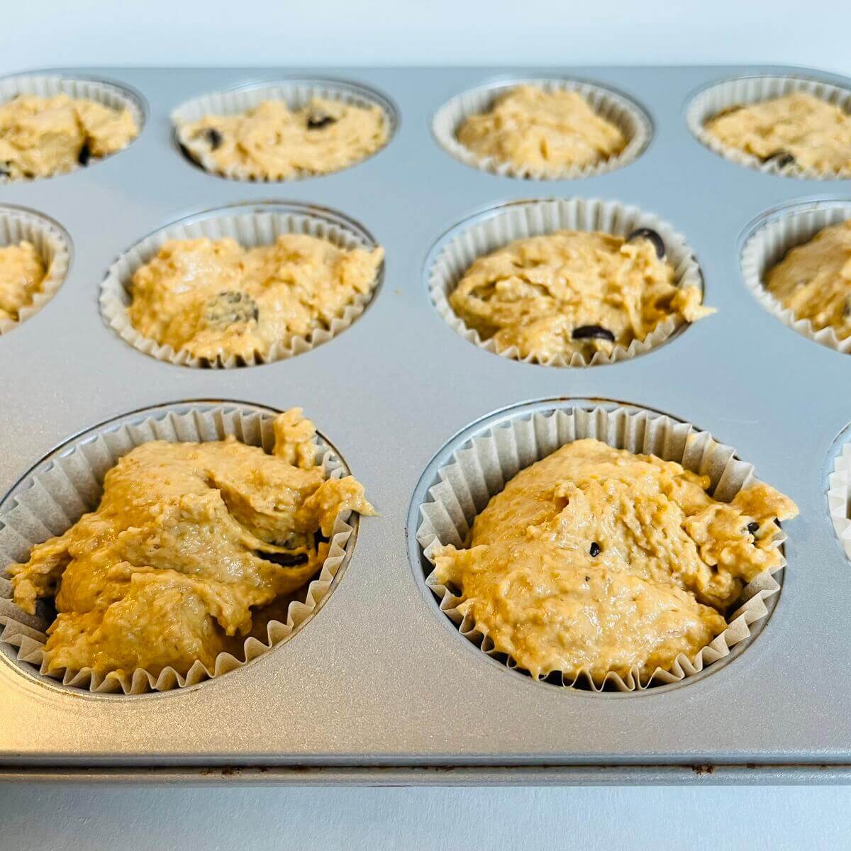 Raw sweet potato muffins in a baking pan.