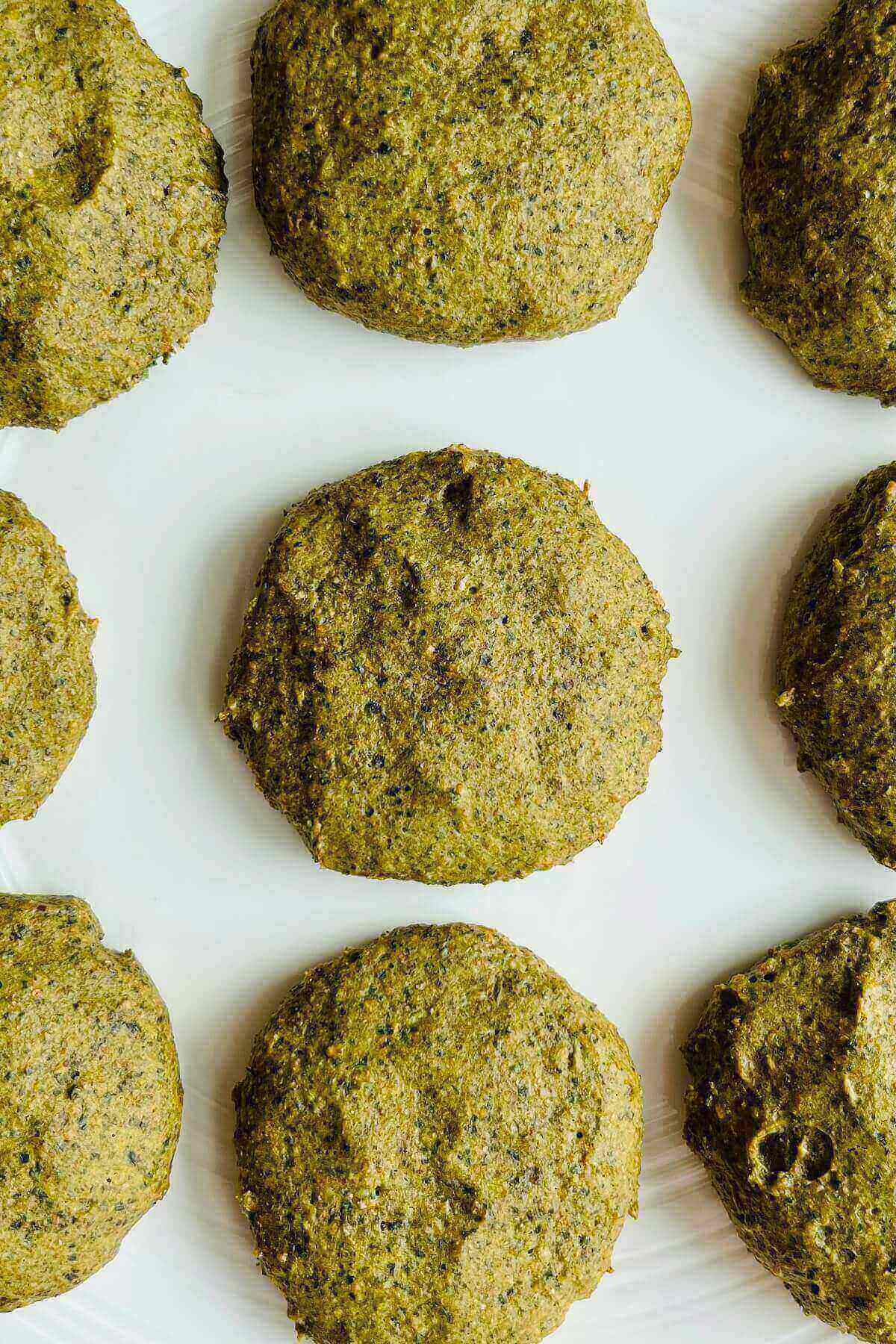 Green cookies on a white plate.