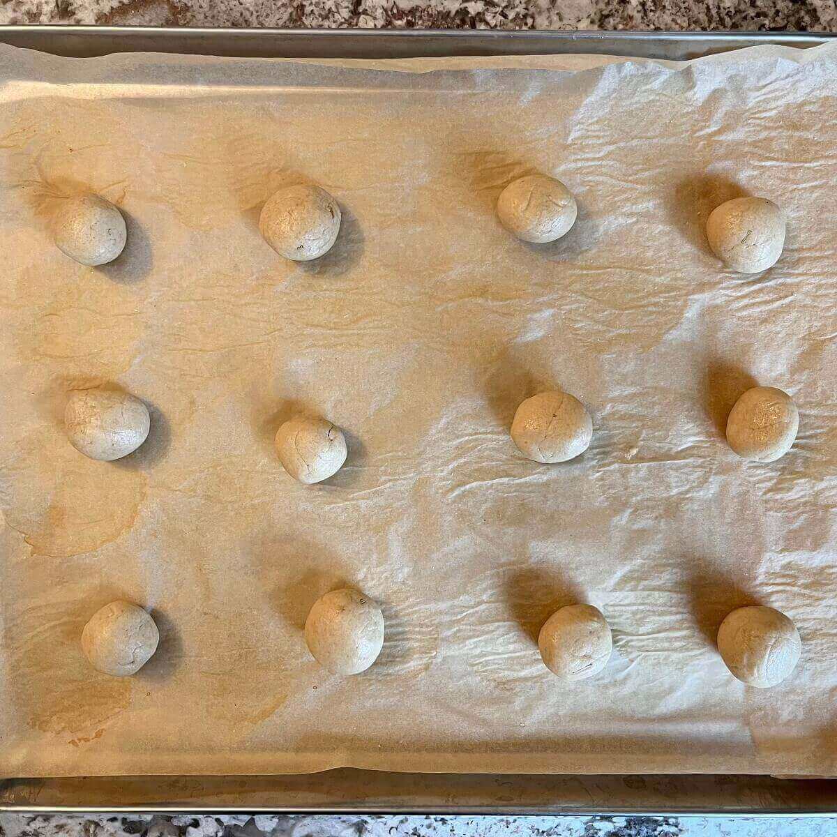 Raw amaranth dough balls on a sheet pan.