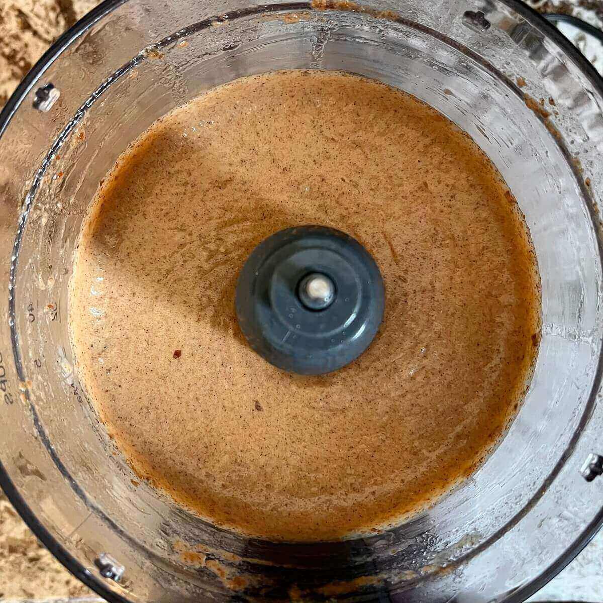 Blended ingredients for a cake batter in a food processor.