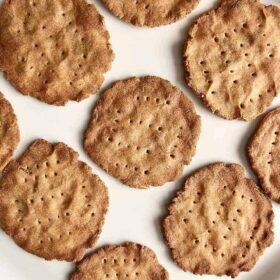 Round crackers on a white plate.