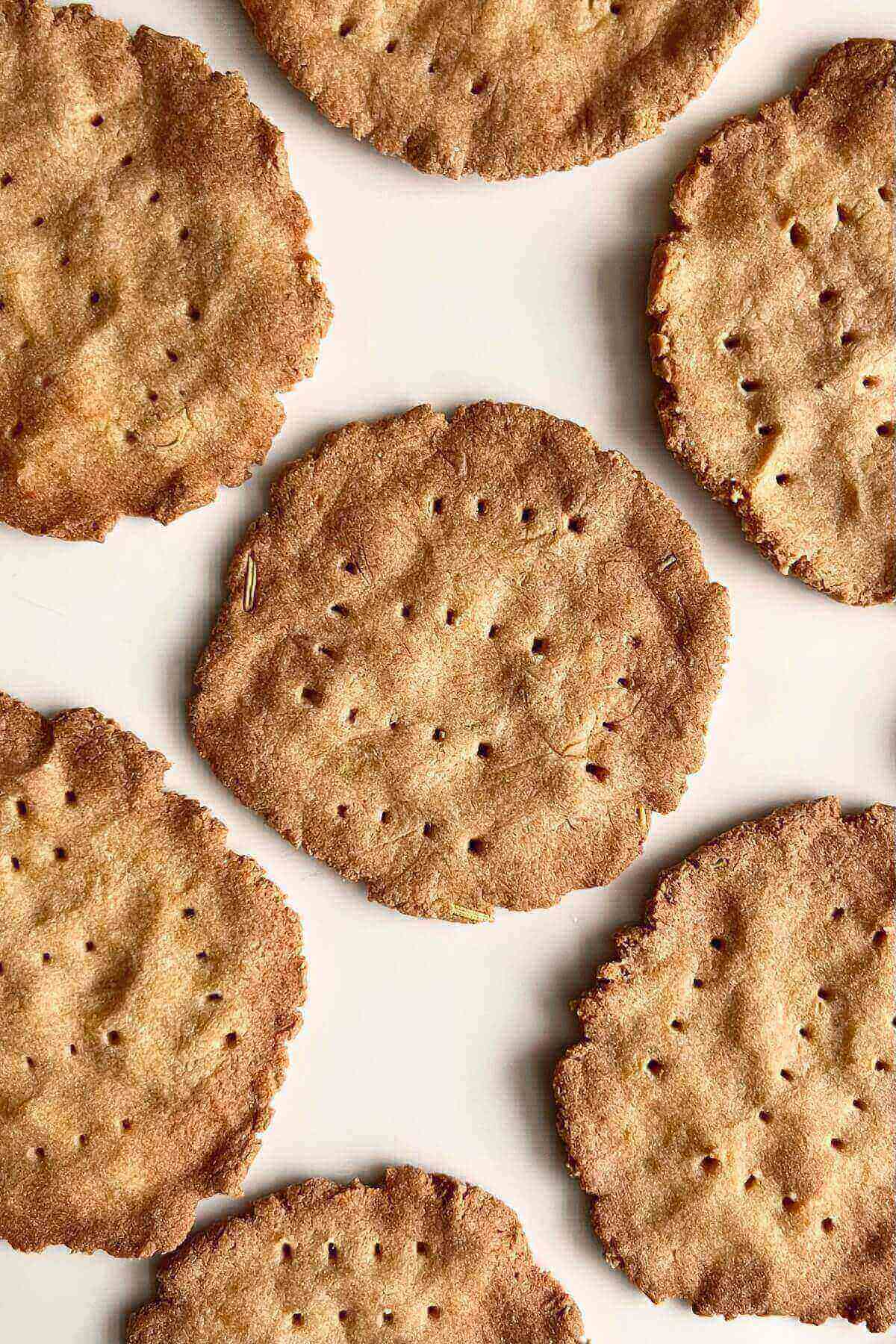 Light brown crackers on a white plate.