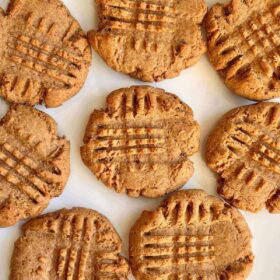 Eight peanut butter date cookies on a white plate.