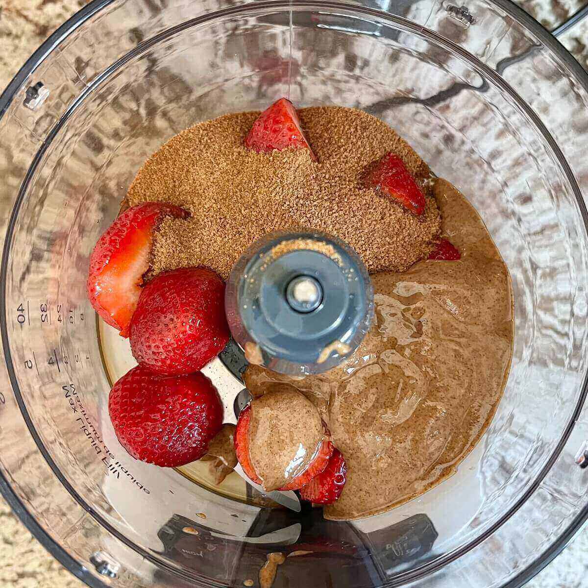 Ingredients for strawberry cookies in a food processor.