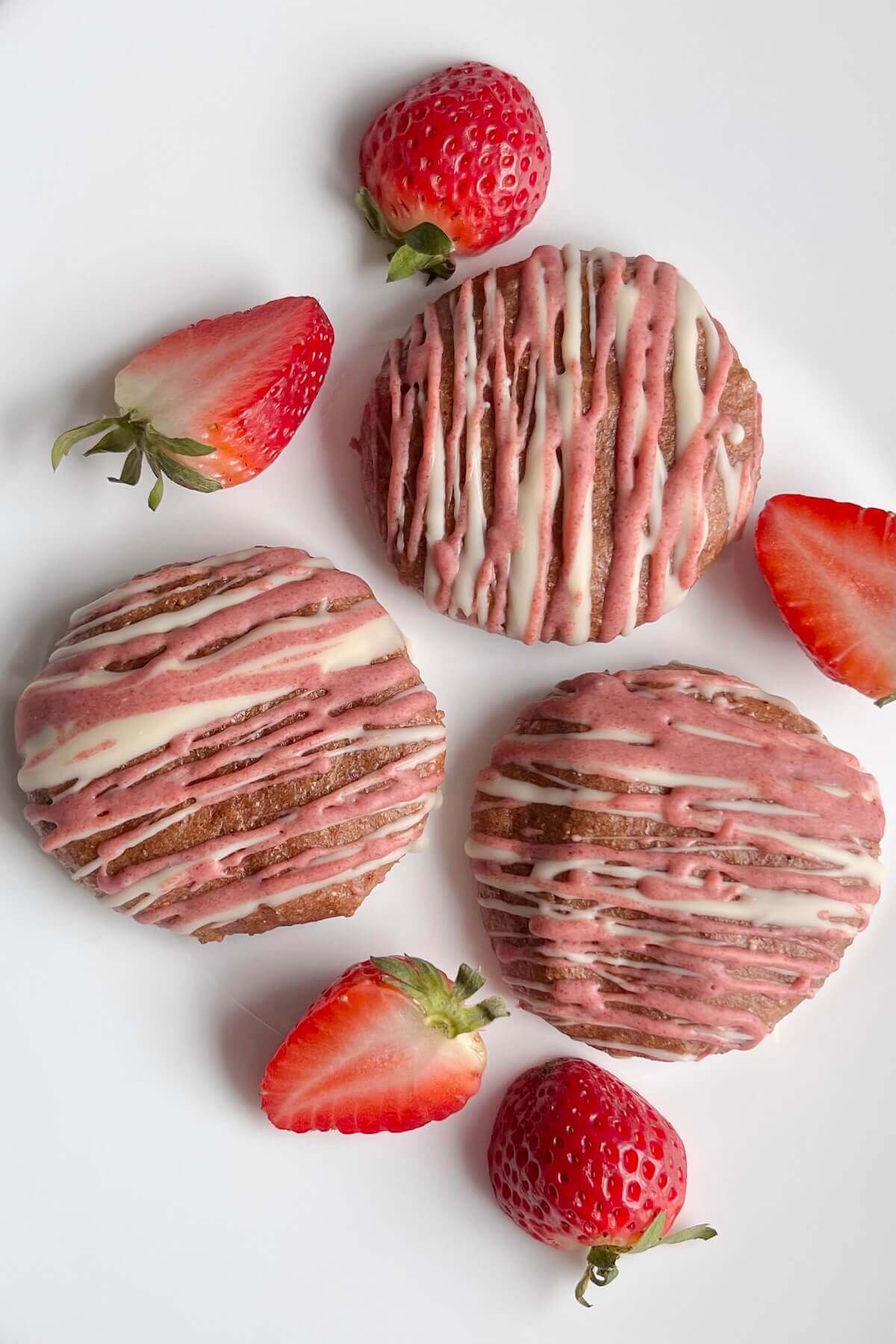 Cookies and strawberries on a white plate.