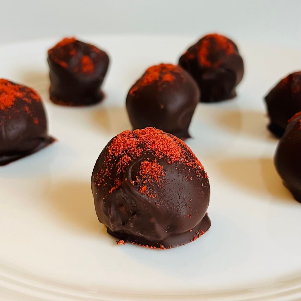 Homemade chocolates on a white plate.