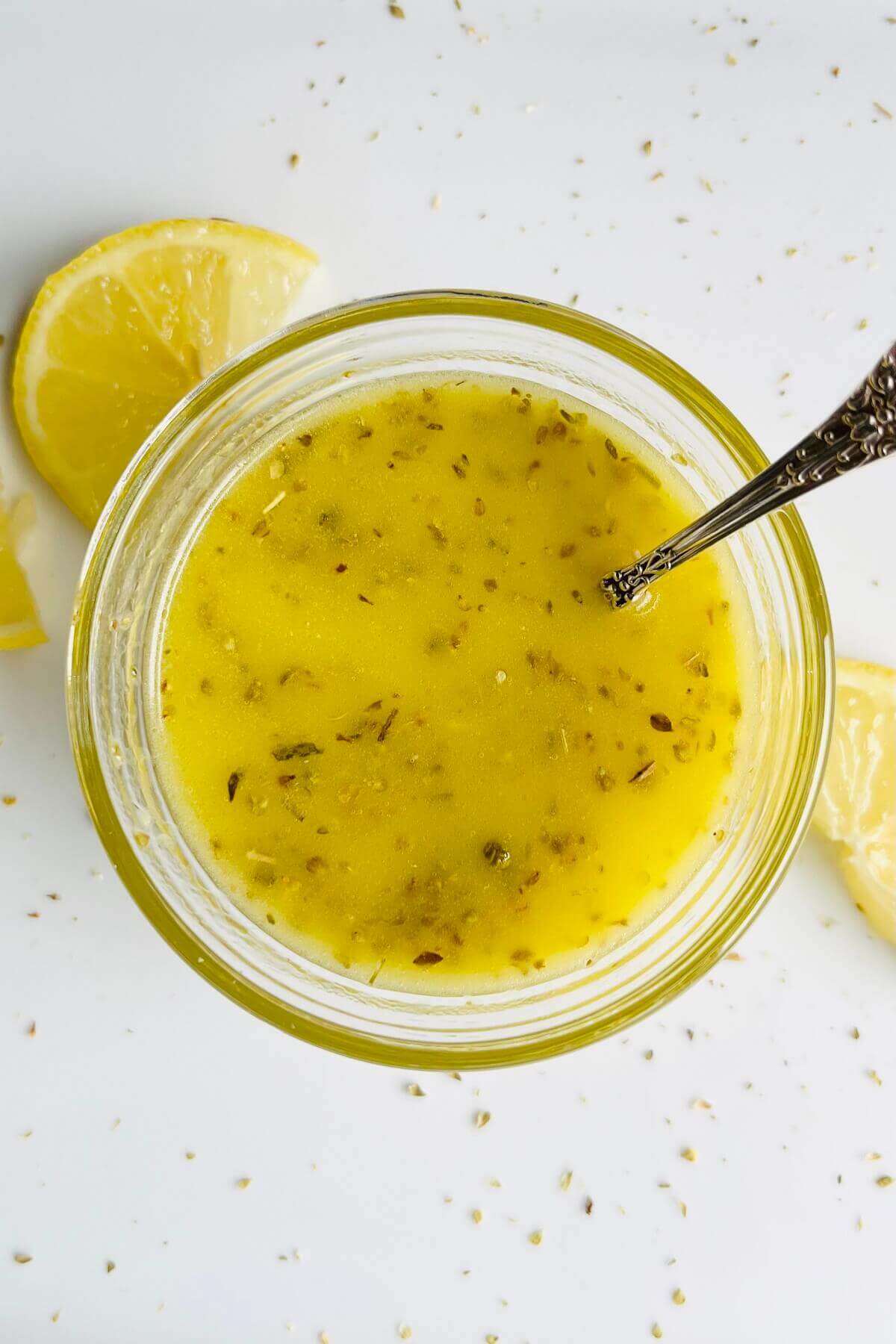 A glass bowl filled with lemon salad dressing.