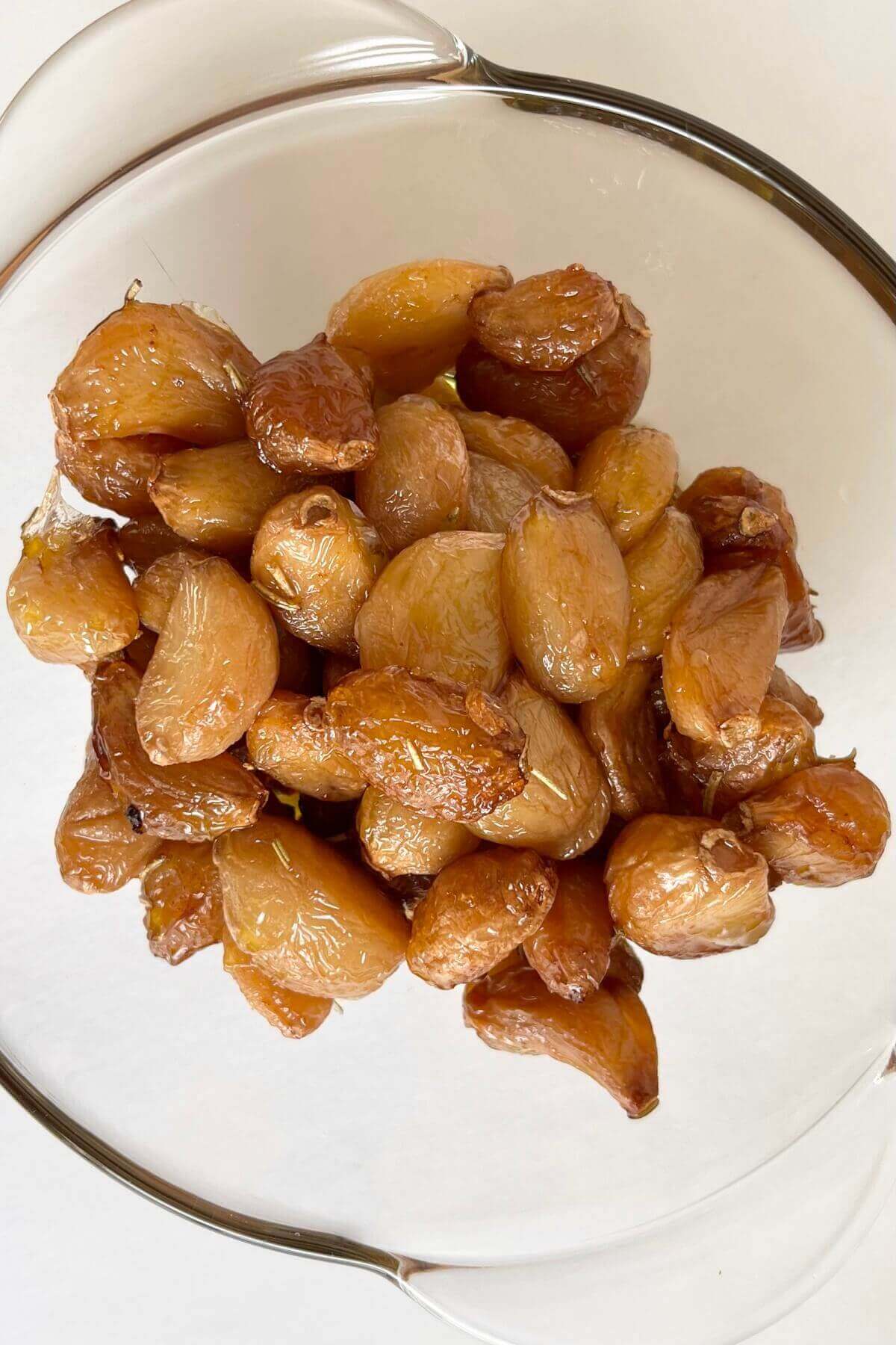 Roasted cloves of garlic in a bowl.