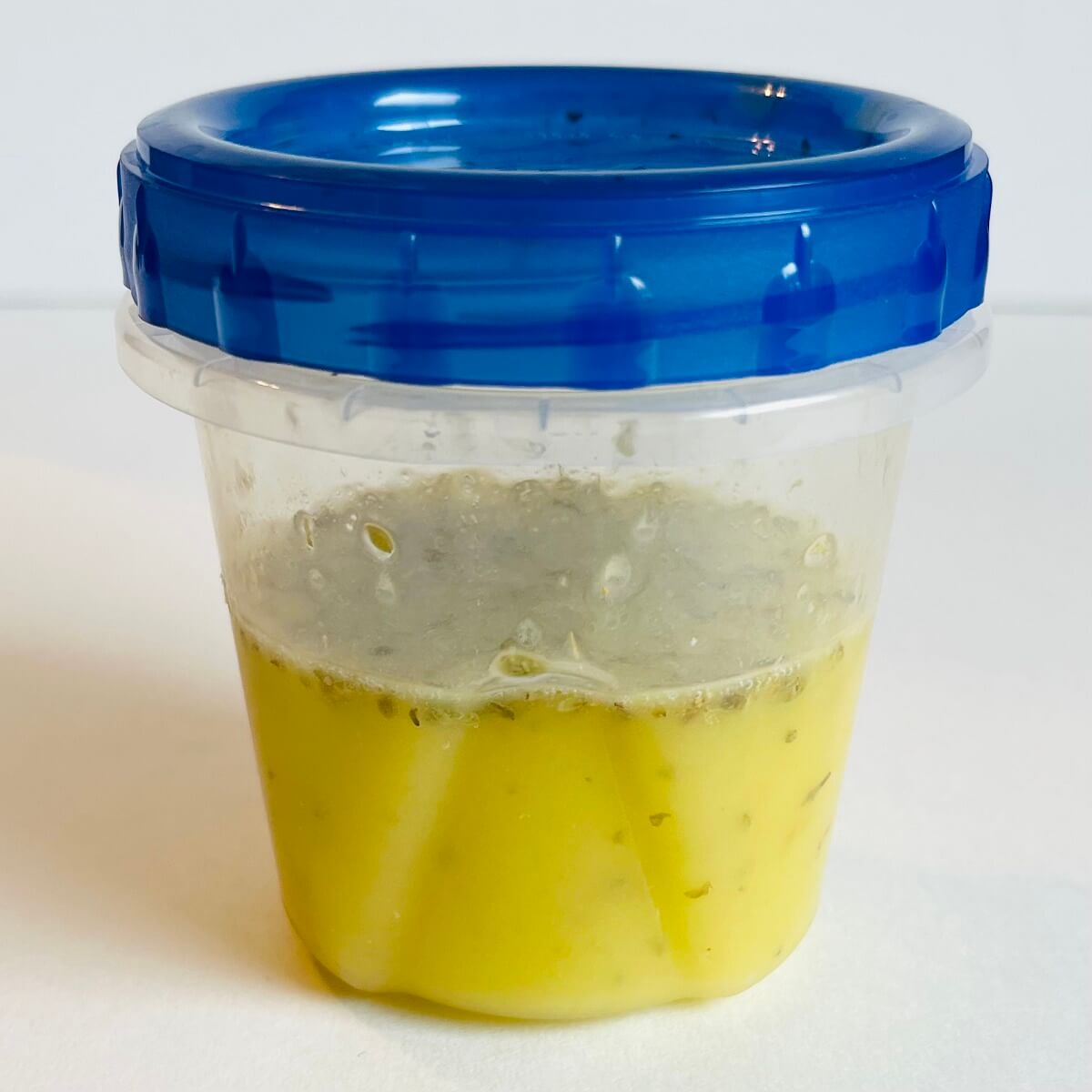 Vinaigrette in a plastic container.