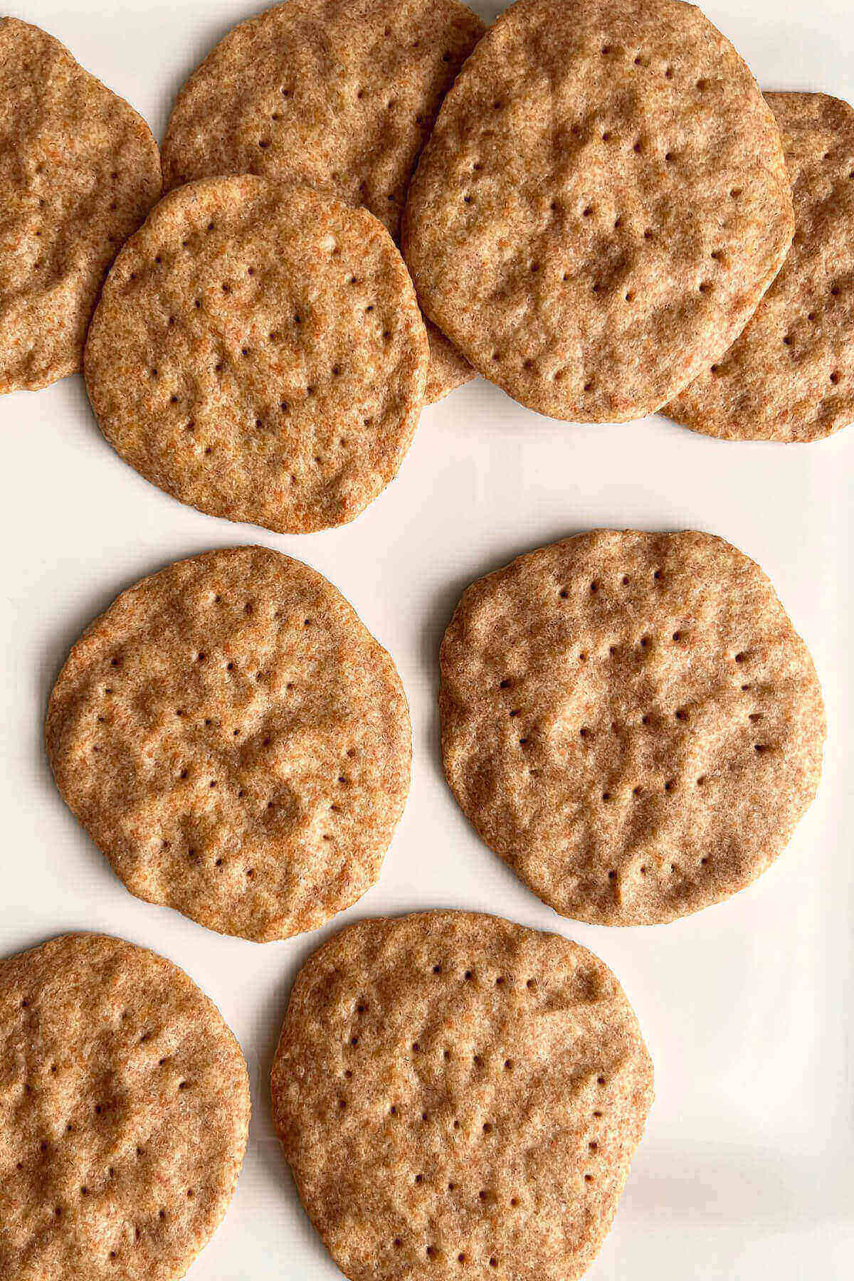 Crackers piled on a white plate.