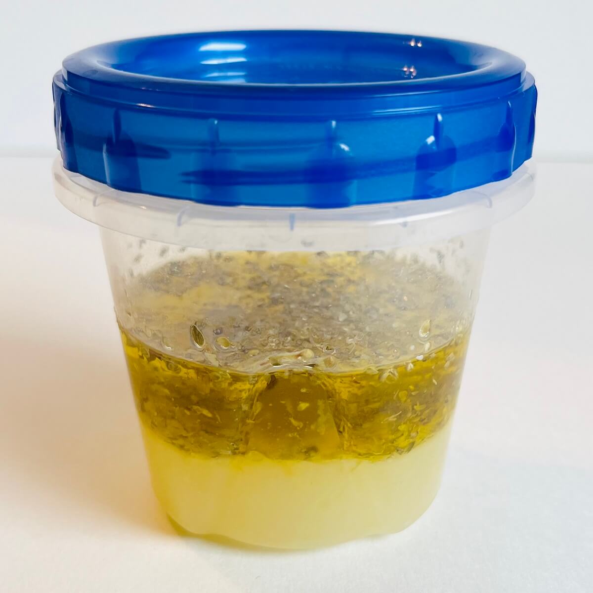Ingredients for vinaigrette in a plastic container.