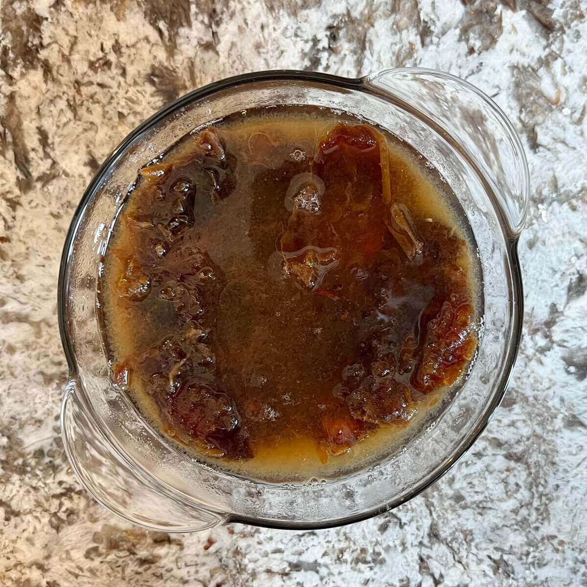 Dates and water in a bowl.