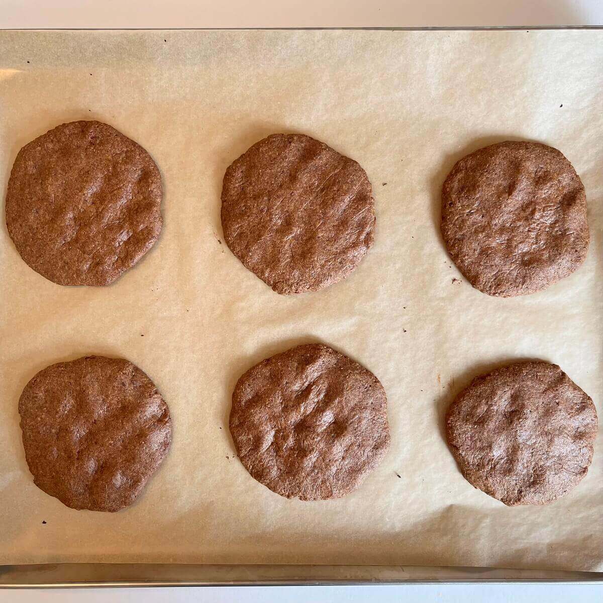 Freshly baked flax cookies on a sheet pan.