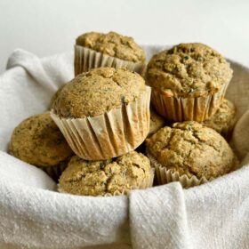 Kale muffins in a basket lined with a linen napkin.