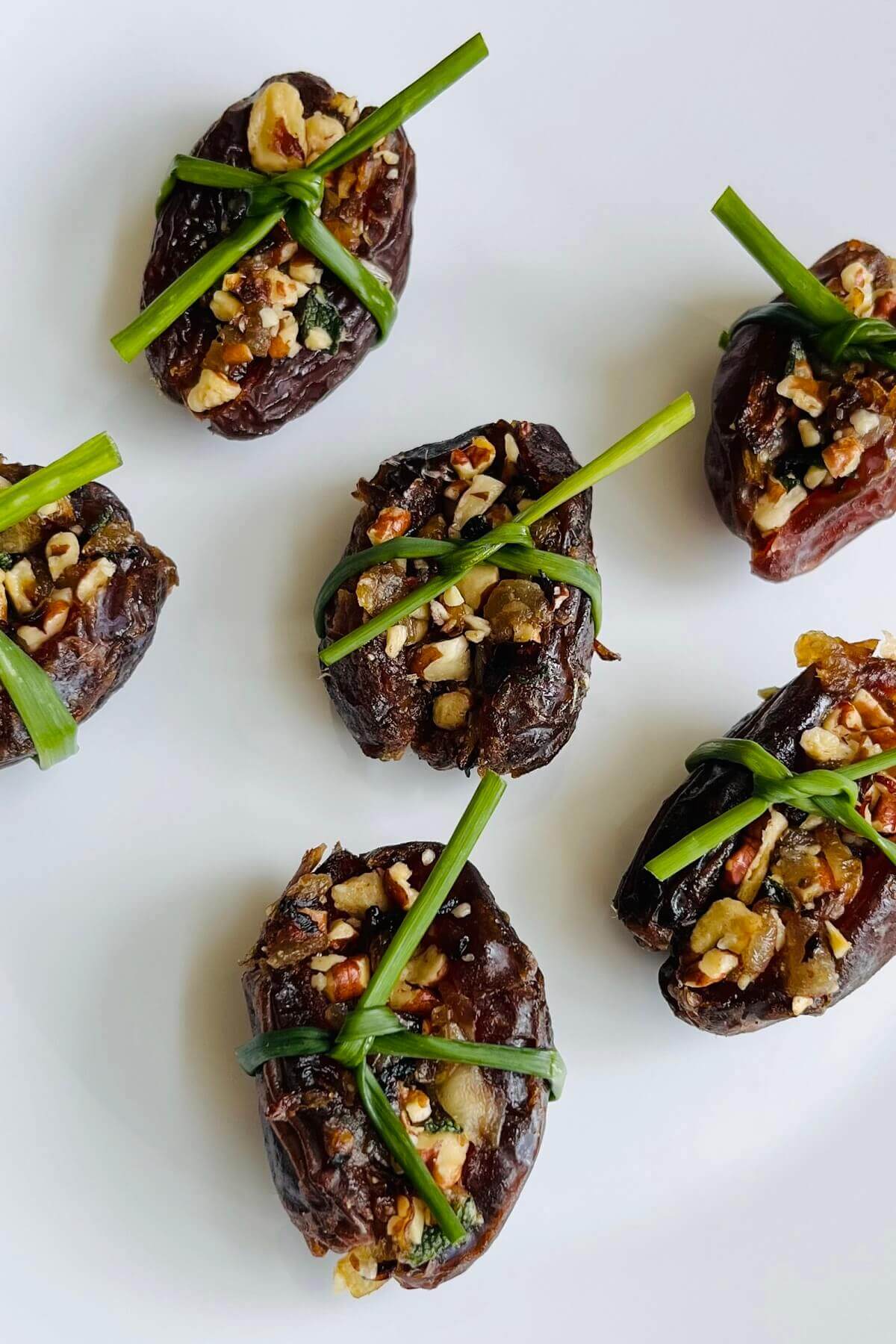 Date appetizers tied with fresh chives.