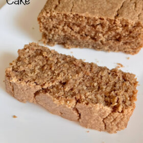 A thick slice of oat cake next to the rest of the loaf cake.