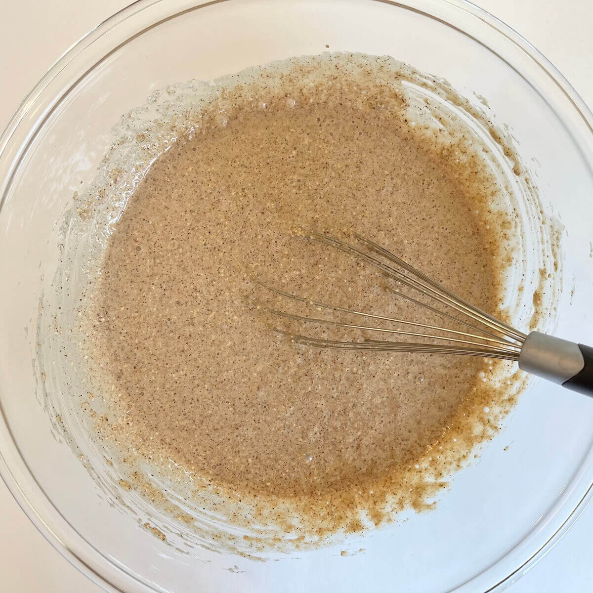 Oat flour batter in a large glass mixing bowl.