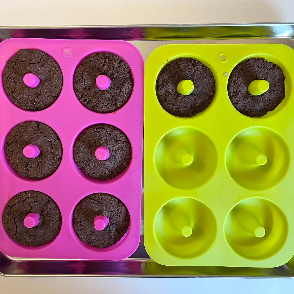 Freshly baked chocolate donuts in silicone molds.
