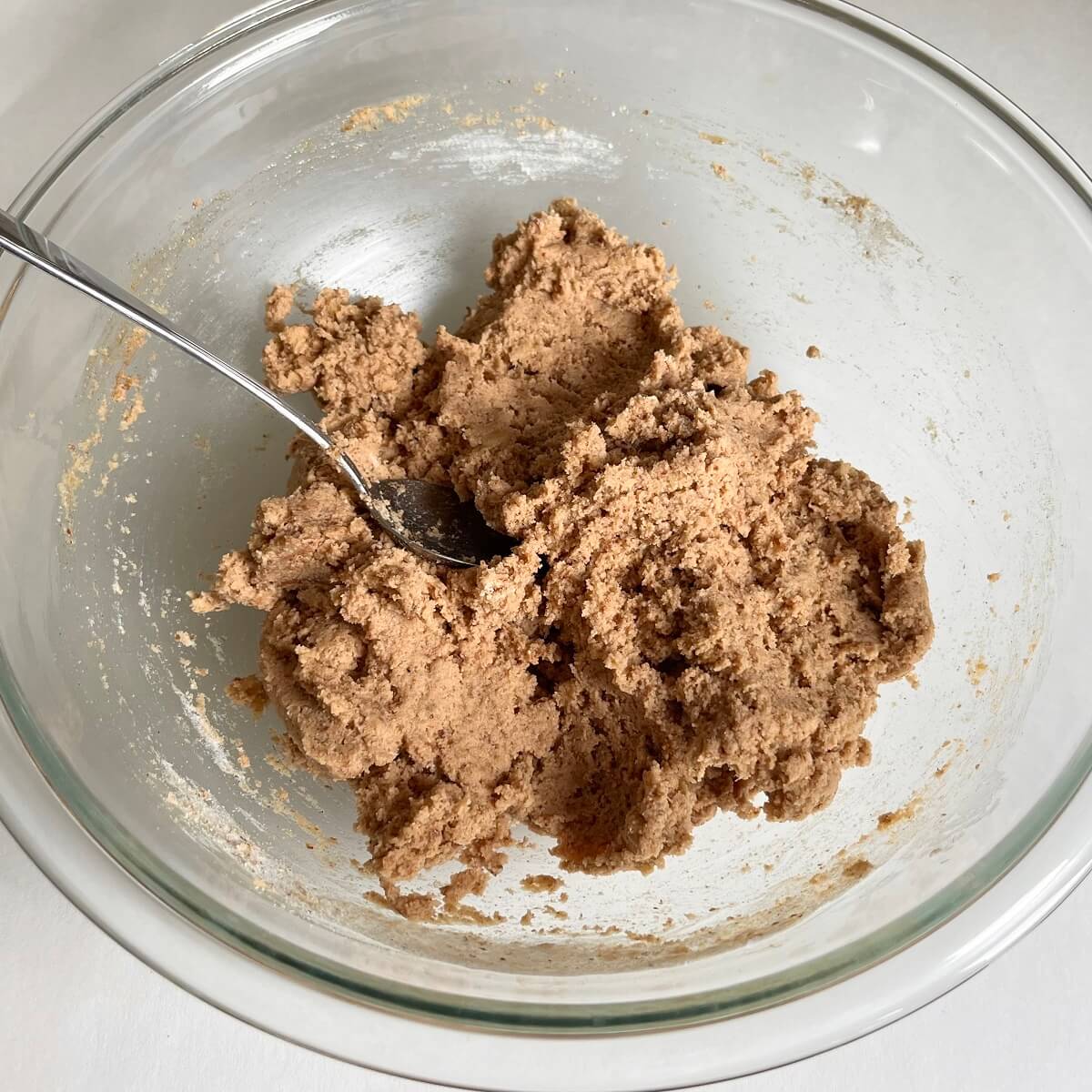 Paleo banana bread batter in a glass mixing bowl.