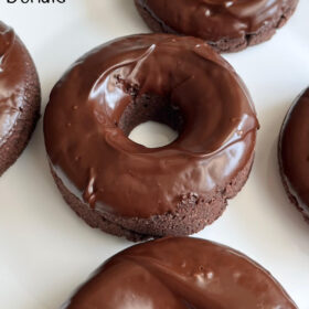 Chocolate donuts on a white plate.
