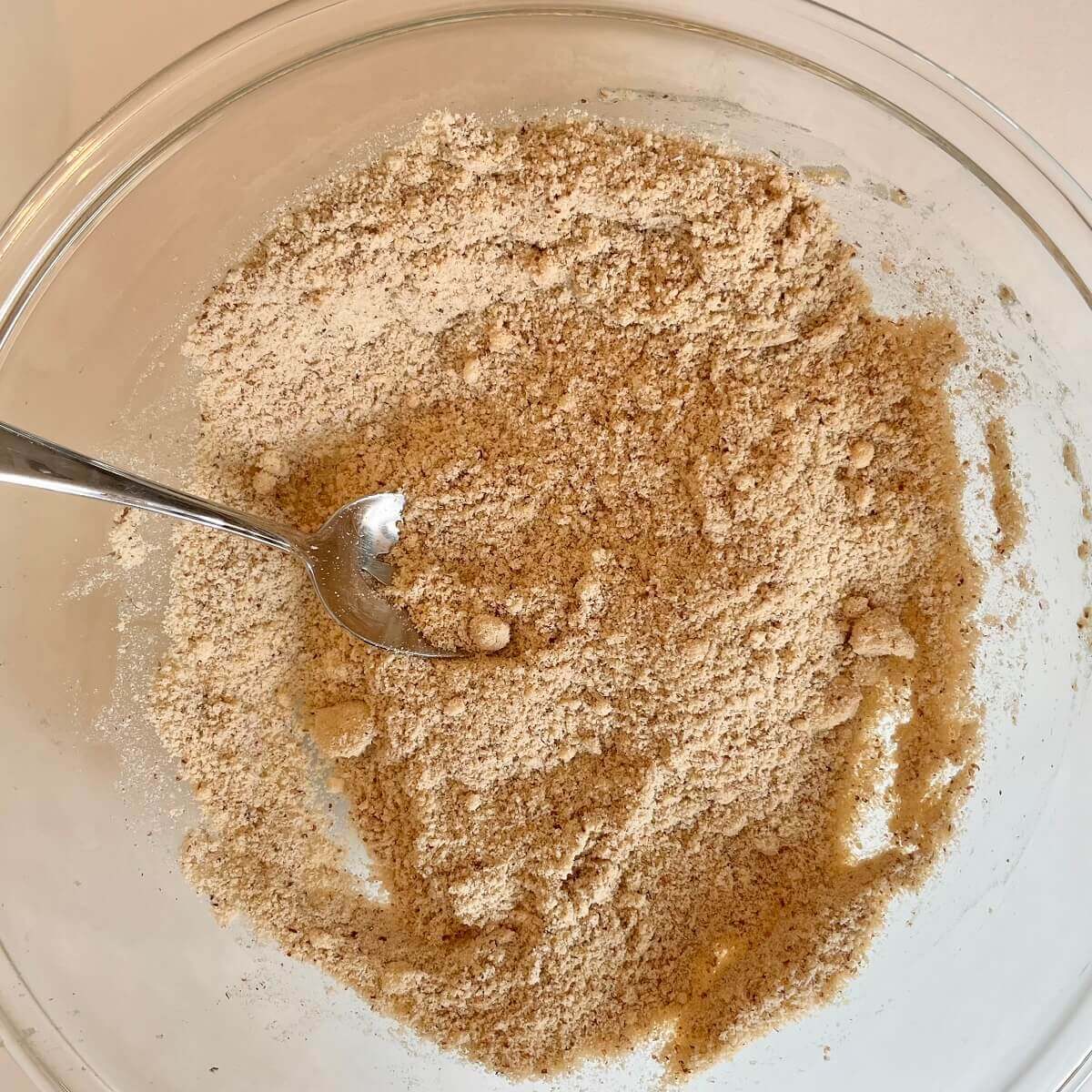 Dry flourless dough ingredients in a glass mixing bowl.