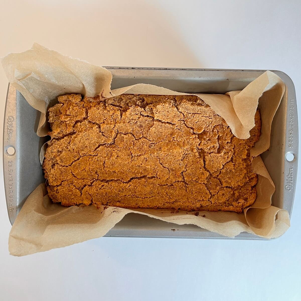 Freshly baked sweet potato bread in a metal loaf pan.