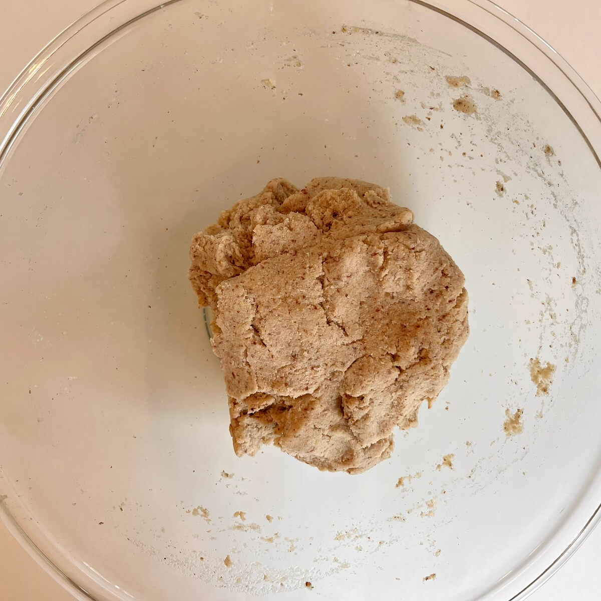 A ball of low-carb vegan dough in a glass bowl.