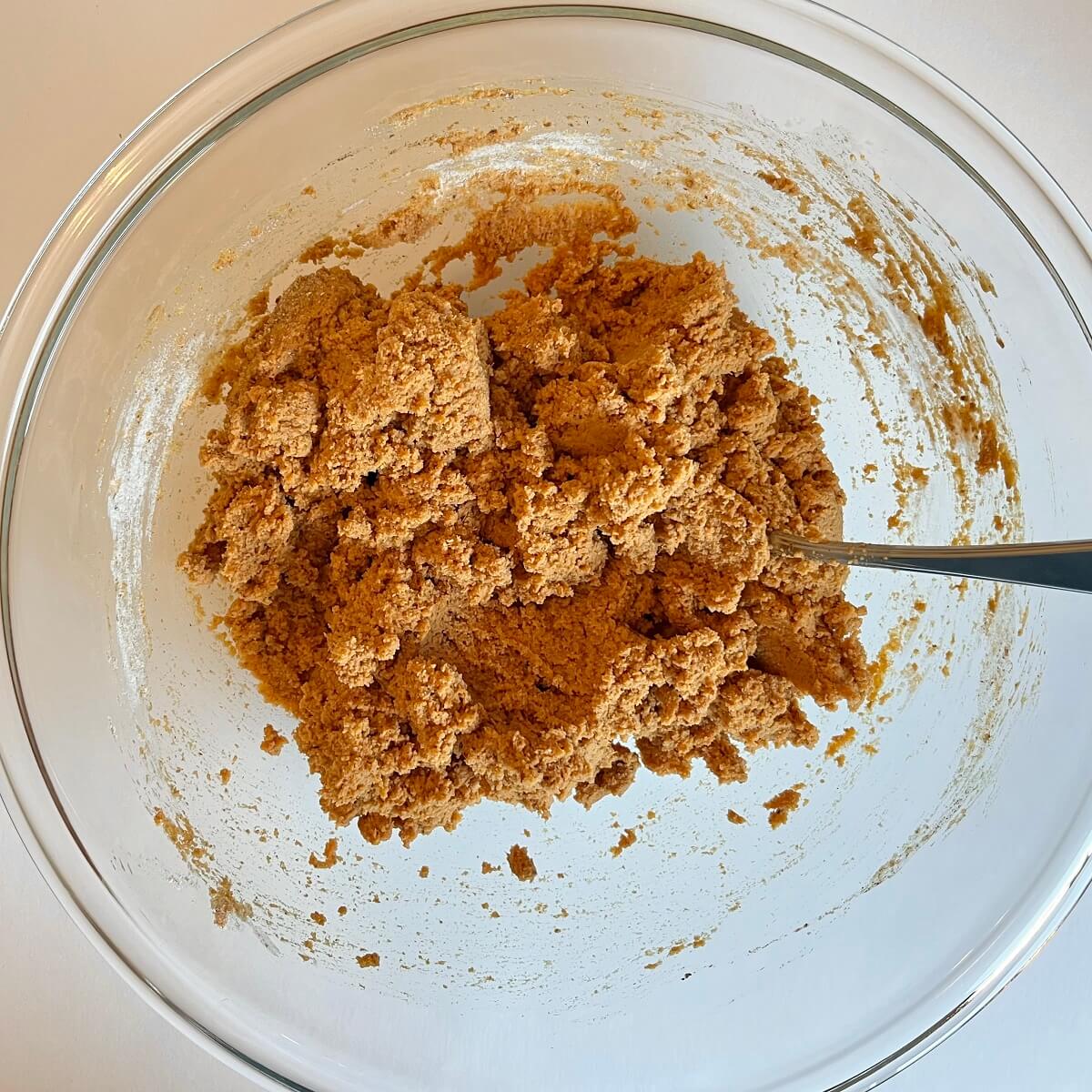 Pumpkin bread batter in a glass mixing bowl.