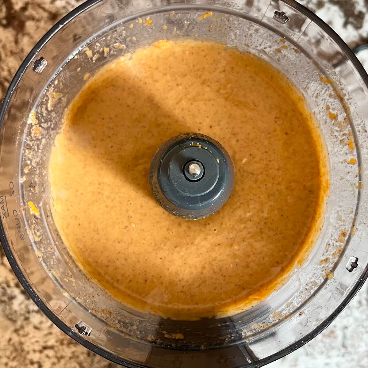 Wet ingredients for sweet potato bread blended in a food processor.