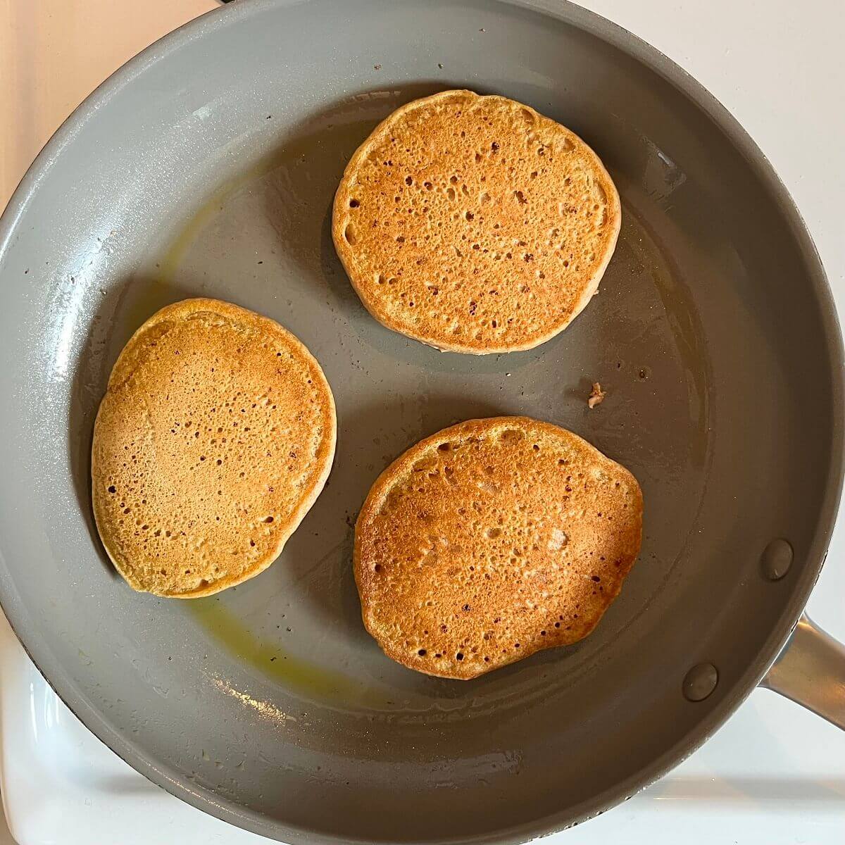 Hot spelt pancakes in a nonstick frying pan.